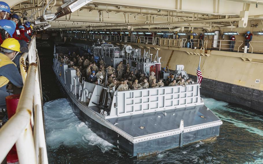 Marines and sailor prepare to depart the USS Boxer