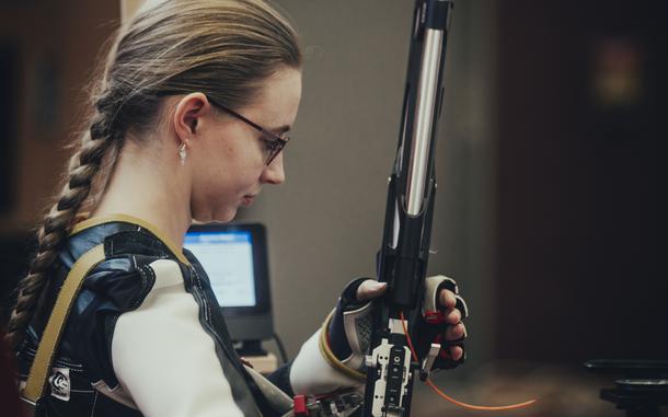 The Stuttgart Panthers' Aurora Mayo, a second-year shooter, adjusts her rifle prior to shooting in the kneeling position during a marksmanship meet in Vilseck, Germany on Dec. 7, 2024. Mayo placed second overall for the day dominating the prone position with a perfect 100 score.