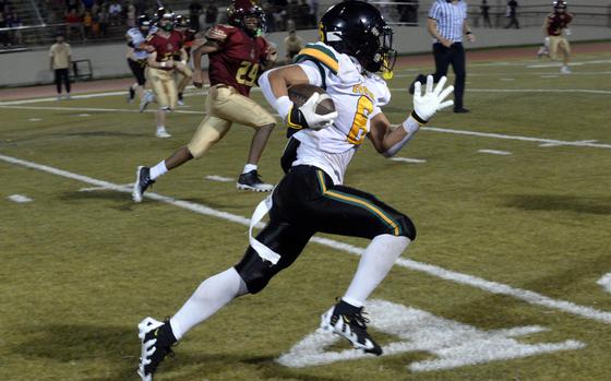 Photo Of P.J. Lorenzo runs with the football.