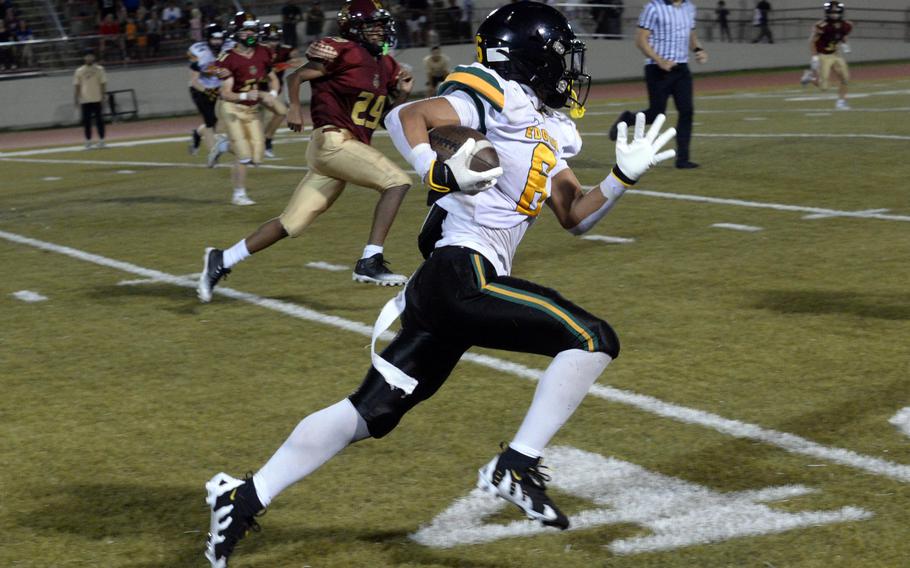 P.J. Lorenzo runs with the football.