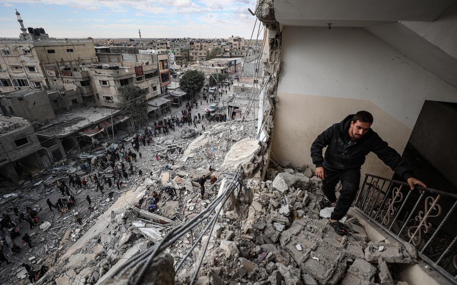 Palestinians inspect their homes on Saturday after the strike on al-Masry Tower.