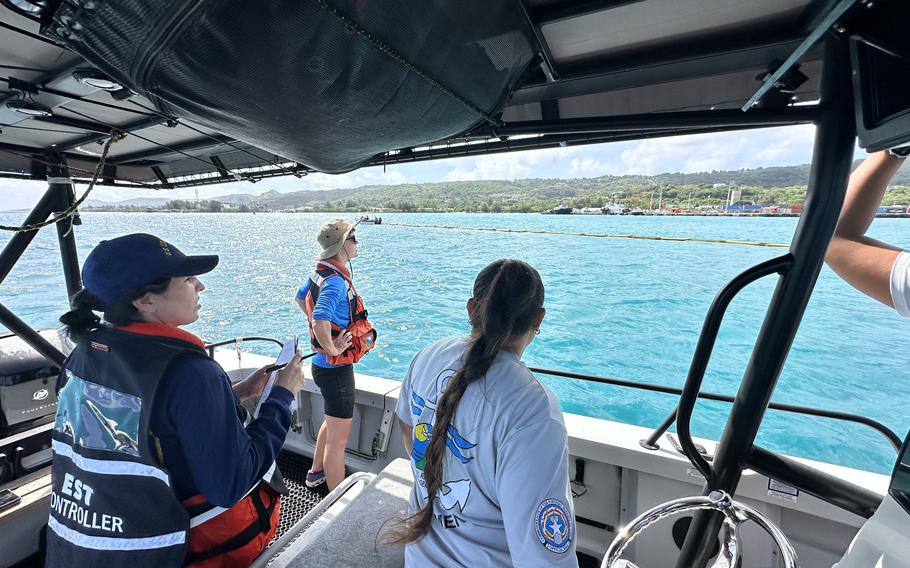 Evaluators from the Coast Guard,Fish and Wildlife Service and the Northern Marianas' Bureau of Coastal Resource Management observe a simulated oil spill response at Saipan on June 26, 2024.
