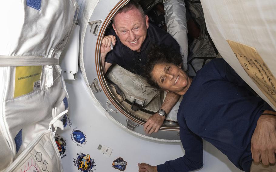 Butch Wilmore and Suni Williams smile as they pose for a portrait.