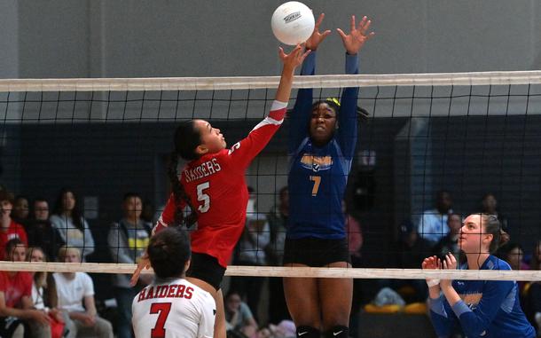 Wiesbaden's Aniyah Brown attempts to block a ball from Kaiserslautern's Kezley Kai in the Division I final of the DODEA-Europe volleyball championships at Ramstein Air Base, Nov. 2, 2024. Wiesbaden beat Kaiserslautern 25-21, 25-21, 17-25, 25-10 to take the title.