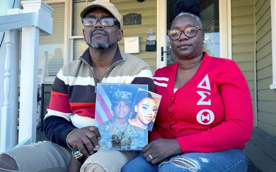 Oneida Oliver-Sanders, right, and Shawn Sanders hold a photograph of their daughter, Sgt. Kennedy Ladon Sanders, at their Waycross GA home Tuesday, January 30, 2024. (Joe Kovac/ Joe.Kovac@ajc.com)