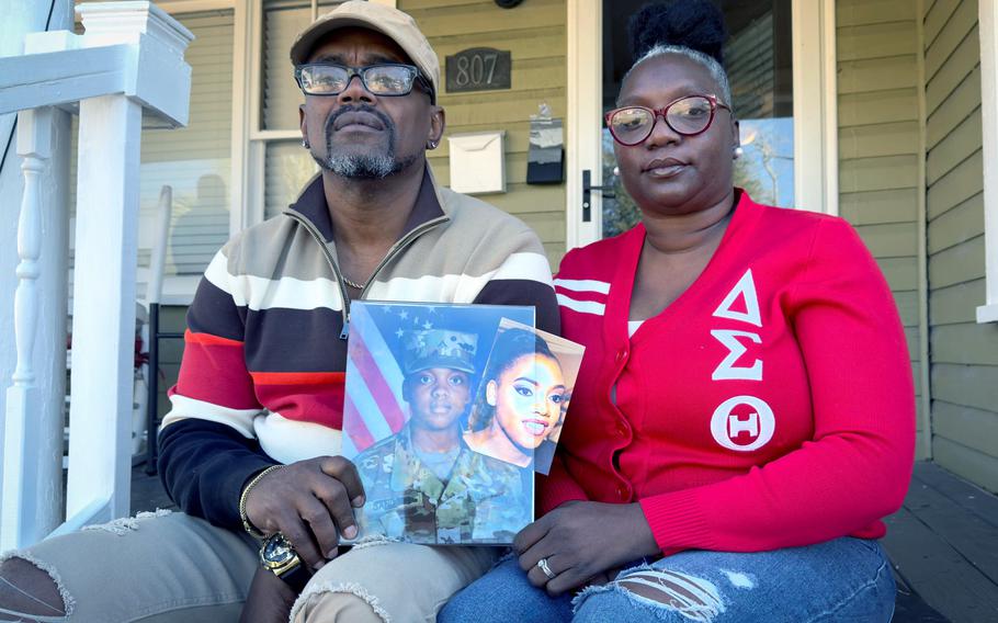 Oneida Oliver-Sanders and Shawn Sanders hold a photograph of their daughter