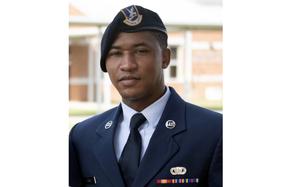 An Airman poses in his dress uniform.