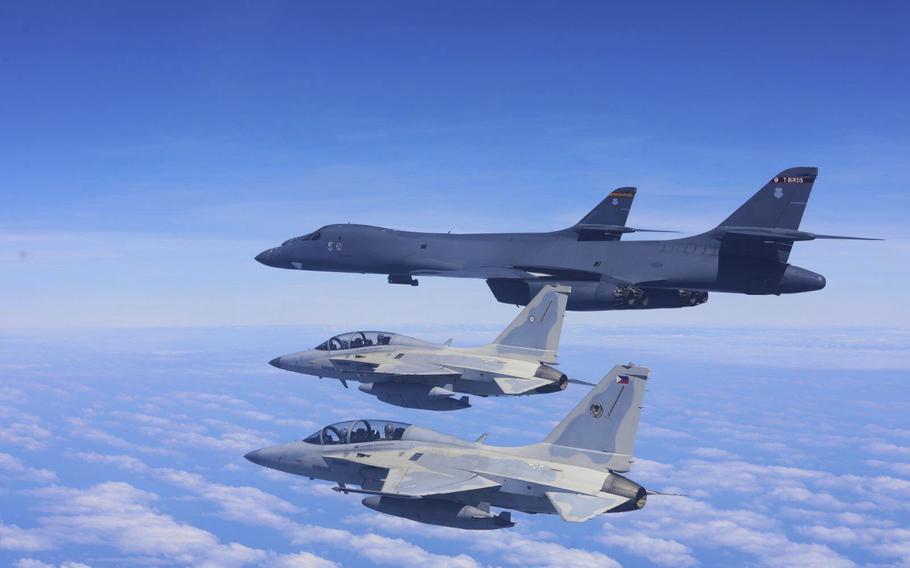 Two Philippine Air Force FA-50 fighter jets fly with two U.S. Air Force B-1 bomber aircraft