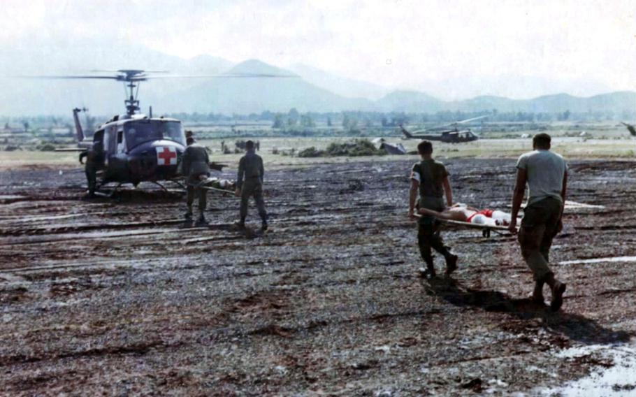 Stretcher-bearers in September 1966 carry wounded