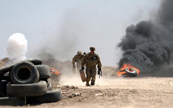 Besmaya training site, Iraq, April 26, 2015: U.S. Army advisers run to safety after lighting tires for realistic effects during an Iraqi army exercise at Besmaya, a coalition training site south of Baghdad.

With live explosives, smoke and rocket fire from helicopter gunships, American troops and their international partners are trying to give Iraqi soldiers a realistic idea of what they can expect when they take on Islamic State militants.

Read the full article here.
https://www.stripes.com/migration/us-advisers-hope-realistic-training-scenarios-help-iraqi-troops-face-islamic-state-fighters-1.343931

META TAGS: Operation Iraqi Freedom; Wars on Terror; U.S. Army; 82nd Airborne Division; training; Iraqi army; Iraqi security forces