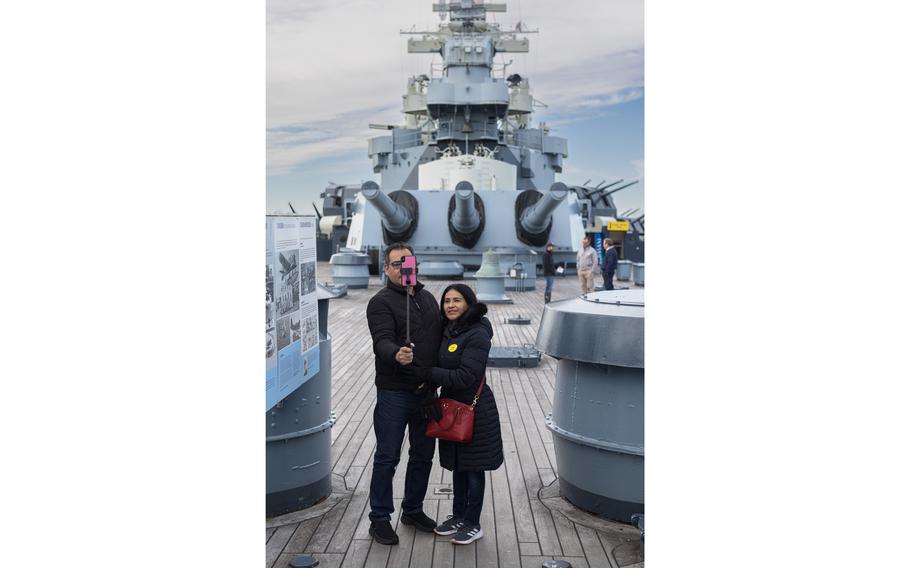 Miguel Mendoza and Iris Valerio take a selfie on the USS North Carolina in Wilmington on Nov. 28, 2023.