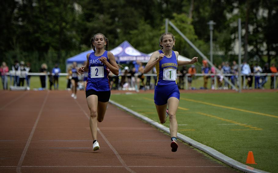 Sigonella’s Isabella Lyon crosses the finish line just ahead of Ramstein’s Cecelia Thompson in the Girls 3,200-meter run at the 2024 DODEA European Championships at Kaiserslautern High School in Kaiserslautern, Germany, on May 24, 2024.