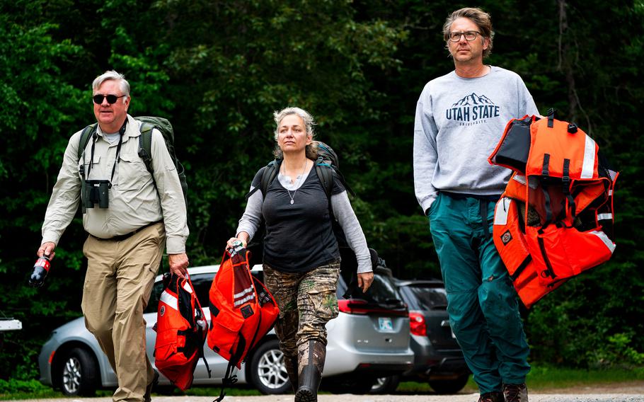 Bald-eagle researcher William Bowerman, left, and biologists Peggy Shrum and Michael Wierda head out for a second day searching for eagles and their offspring at Voyageurs park on June 15.