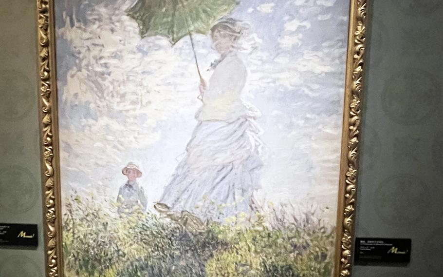 A print of "Woman With a Parasol - Madame Monet and Her Son" by Claude Monet at the Kadokawa Culture Museum in Tokorozawa, Japan.