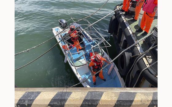 In this photo released by the Taiwan Coast Guard, Taiwan's coast guard officials are seen on board a speedboat that an alleged former Chinese naval officer used to enter a harbor in New Taipei city, Taiwan on Monday, June 10, 2024. Taiwanese authorities are investigating how the Chinese man had driven the small boat into a strategic river mouth that leads to the capital of the self-governing island republic. (Taiwan Coast Guard via AP)