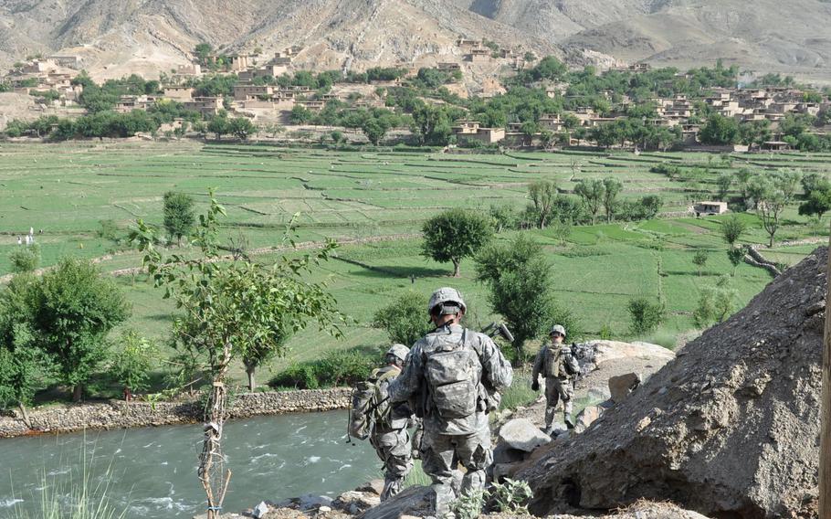 Soldiers climb down the mountainside