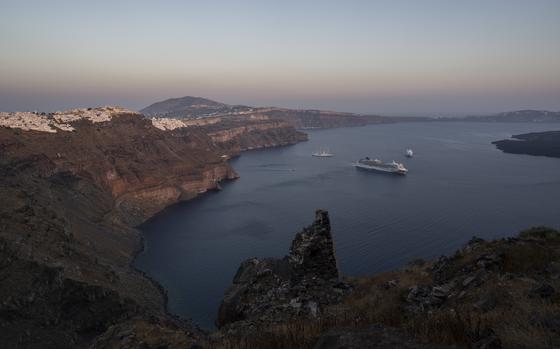 FILE - Ruins of a settlement, including a former Catholic monastery, lie on the rocky promontory of Skaros on the Greek island of Santorini, Wednesday, June 15, 2022. (AP Photo/Petros Giannakouris, File)