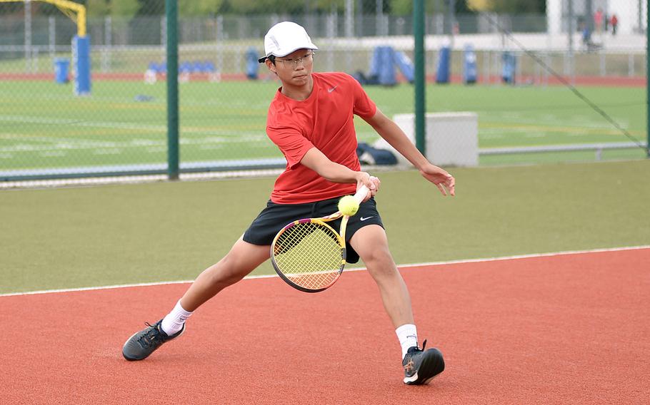 Kaiserslautern's Bryan Oh hits the ball during a boys doubles match with teammate Leo DiPaola against Ramstein's Elliot Radosevich and Bernie Novak on Sept. 14, 2024, at Ramstein High School on Ramstein Air Base, Germany.