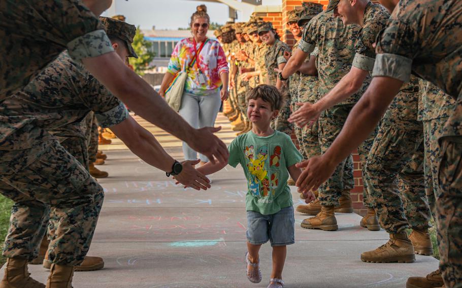 U.S. Marines cheer for a teacher and her son during a back-to-school celebration at the Crossroads Elementary School on Marine Corps Base Quantico, Va., Aug. 21, 2024. 