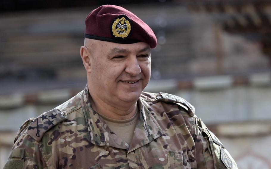 A man in military fatigues and a red beret.