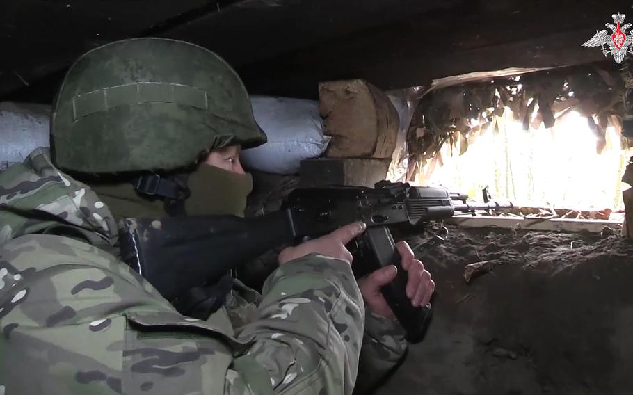 A Russian soldier takes aim from a bunker near the Russian-Ukrainian border in the Kursk region of Russia, October 24, 2024.