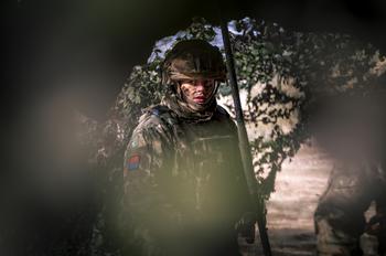 A U.K. soldier stands at his unit’s command and control center during an exercise. 