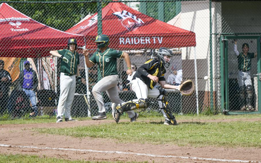 SHAPE’s Ethan Simmons sprints past Stuttgart catcher Declan Mack to score in the first inning of a 2024 DODEA European baseball championship game on May 22, 2024, at Southside Fitness Center on Ramstein Air Base, Germany.
