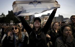 Relatives and friends of people killed and abducted by Hamas and taken into Gaza, react as they gather in Tel Aviv, Israel on Sunday, Jan. 19, 2025. (AP Photo/Oded Balilty)