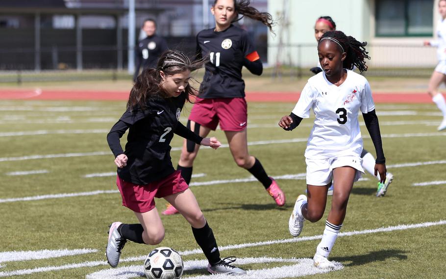 Matthew C. Perry's Leilena Washington and E.J. King's Tiffany Nabutete chase the ball during Friday's Western Japan Athletic Association girls soccer match. The Samurai beat the defending champion Cobras 1-0.