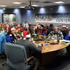 Volunteers at the NORAD Tracks Santa Operations Center in Colorado Springs, Colo., inform callers of Santa's location and the number of gifts he's delivered Dec. 24, 2022. 