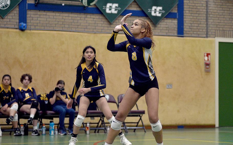 Ansbach’s Laila McIntyre prepares to bat away a ball during a match against Brussels on Oct. 7, 2023, at AFNORTH International School in Brunssum, Netherlands. Watching in the background is teammate Kyla Tuazon.