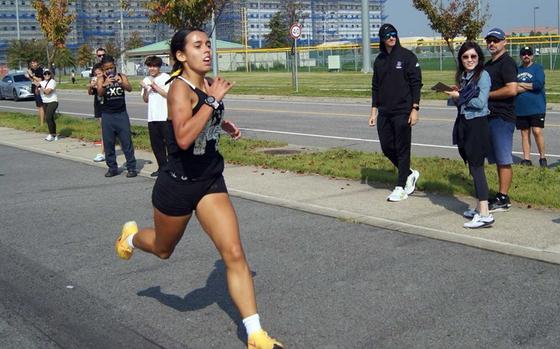 With the eyes and iPhones of spectators all around, Humphreys sophomore Cassandra Jarzabek charges across the finish line in a Pacific-record time of 17 minutes, 58.0 seconds during Saturday's Korea regular-season ending meet.