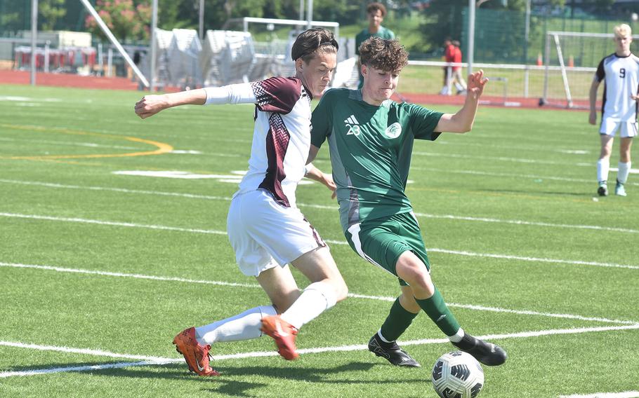 Vilseck's Mason Money, left, and SHAPE's Marcos Gomez battle for the ball in the Spartans' 7-0 victory Monday, May 20, 2024, on the opening day of the DODEA European Division I boys soccer championships at Kaiserslautern High School.