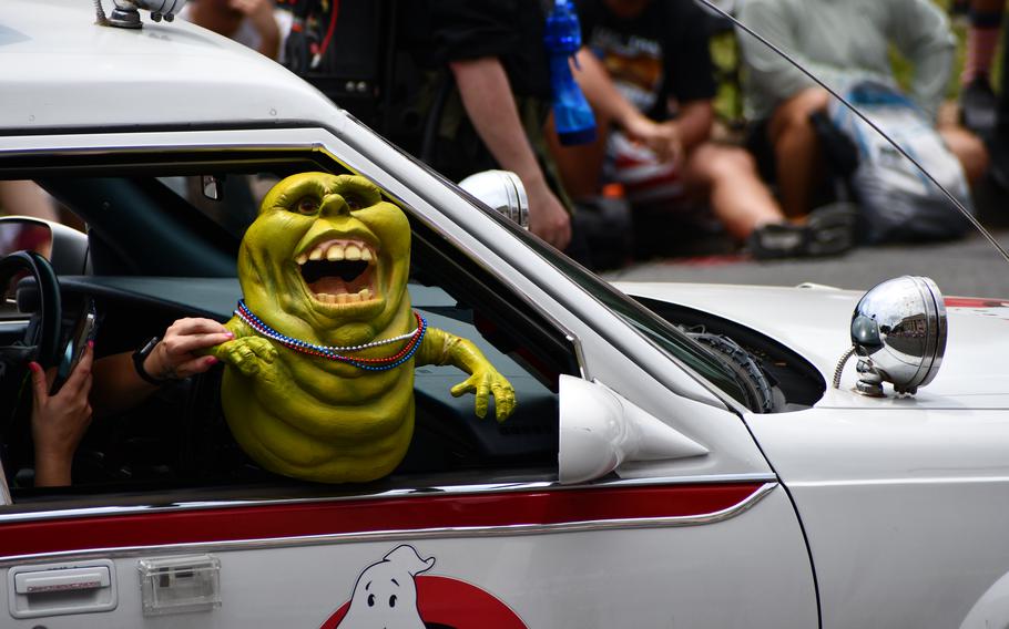 Infamous green ghost ‘Slimer’ hangs outside the passenger window of a Ghostbusters car in the Washington, D.C. Independence Day parade, held on July 4, 2024.