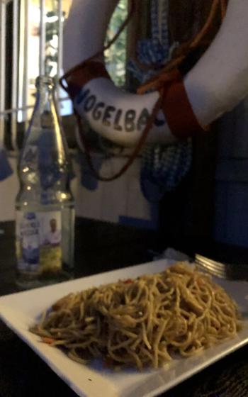 Noodles on a plate with a life preserver in the background