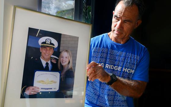 Derek Alkonis holds a picture of his son, U.S