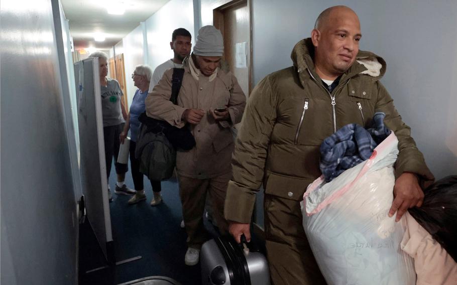 Venezuelan migrants leave with donated clothing at St. Catherine of Siena-St. Lucy Catholic Church in Oak Park, Ill., on Oct. 5, 2023.