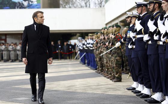 French President Emmanuel Macron reviews the troops during a military ceremony during a visit at the Digital Support and Cyber Command (CATNC) of the French Army as part of his New Year address to the Armed Forces, in Cesson-Sevigne, western France, Monday, Jan. 20, 2025. (Stephane Mahe/Pool via AP)