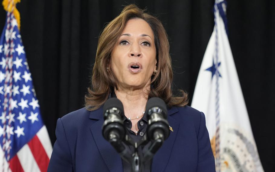 Kamala Harris speaks while standing in front of a U.S. flag.