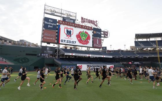 Military service members go through high intensity interval training at Nationals Park in Washington on July 16, 2024.