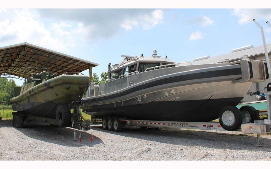 A Riverine Patrol Boat, left, and a Coastal Fast Response Boat sit side-by-side at the Silver Ships boatyard in Theodore, Ala.