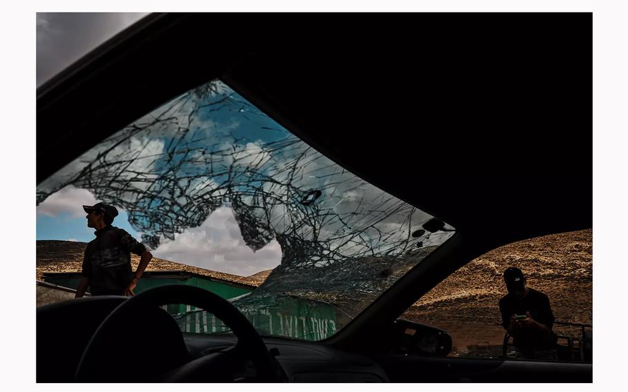 Palestinian boys inspect the windshield of a vehicle that was damaged by Jewish settlers who stoned it in Wadi Tiran in the occupied West Bank. 