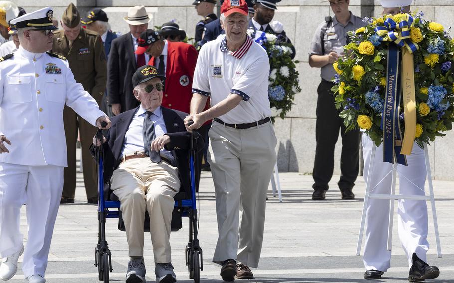 Chaplain Travis Gardner and veteran Jeff Donahue place a wreath at the 20th anniversary celebration of the National World War II Memorial in Washington, May 25, 2024.