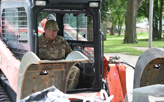 U.S. Air National Guard Tech. Sgt. Aaron Jacobson, a 185th Air Refueling Wing Civil Engineering Squadron Pavements and Construction Equipment specialist, picks up debris using a skid steer loader in Sioux Rapids, Iowa, June 29, 2024. Airmen of the 185th ARW and 132nd Wing were tasked by Iowa National Guard state headquarters to assist in debris cleanup in the wake of historic flooding in Northwest Iowa. 