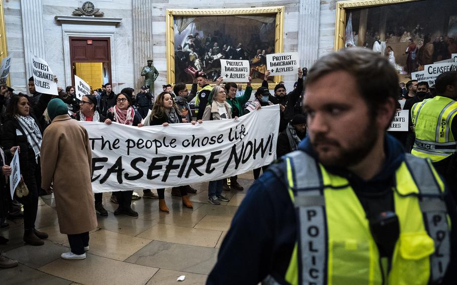 Activists in the U.S. Capitol Rotunda on Dec. 19, 2023, protest U.S. aid to Israel and hostilities in Gaza. 