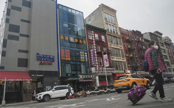 A six story glass facade building, second from left, is believed to be the site of a foreign police outpost for China in New York's Chinatown, Monday April 17, 2023. Justice Department officials say two men have been arrested on charges that they helped establish a secret police outpost in New York City on behalf of the Chinese government. (AP Photo/Bebeto Matthews)