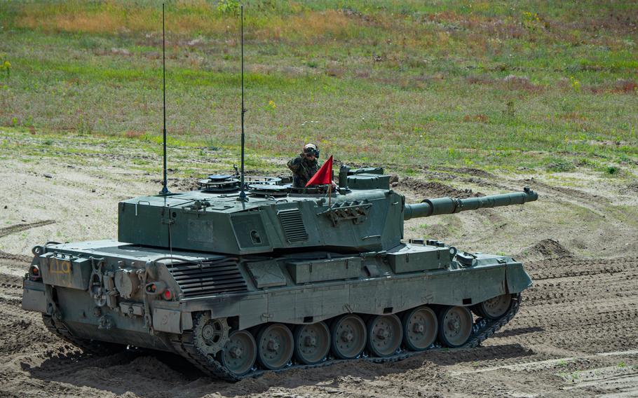 A Ukrainian tank commander scans the area behind his Leopard 1 A5 tank during a live-fire exercise June 13, 2024, at the Klietz training range, Germany.