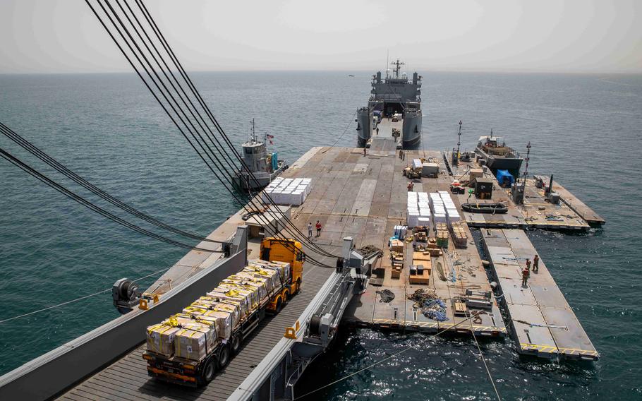 An aid truck uses the roll-on, roll-off distribution facility to transport humanitarian aid onto a U.S. Army vessel on May 20, 2024.