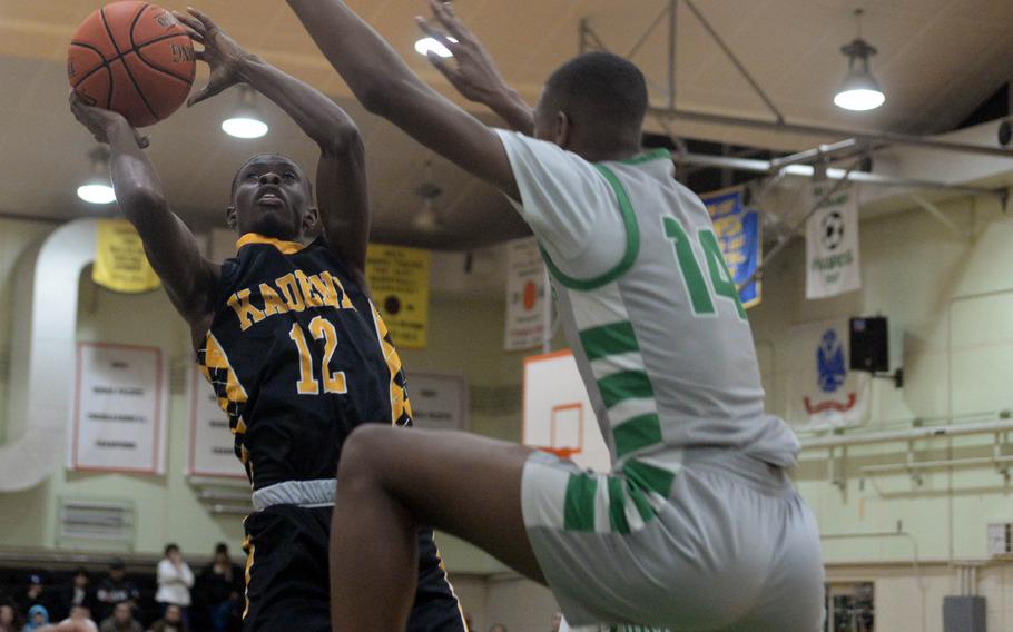 Javier Williams takes a contested shot.