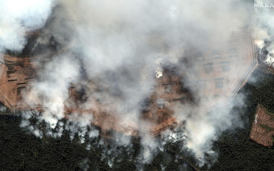 Smoke rises from a series of explosions at an ammunition depot in Toropets, Russia